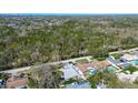 An aerial view shows homes and a wooded area, providing privacy and a natural landscape at 2100 Mcmullen Rd, Largo, FL 33771