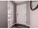 Bright entryway featuring decorative glass window and white front door leading into the home at 2100 Mcmullen Rd, Largo, FL 33771