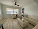 Well-lit living area with comfortable seating, ceiling fan, and modern artistic touches at 250 Rosery Nw Rd # 329, Largo, FL 33770
