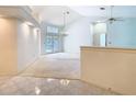 Bright living room with a high ceiling, tile flooring, a chandelier, and glass doors to the backyard at 2725 Onizuka Ct, Palm Harbor, FL 34683