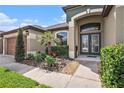 Close up view of a beautiful home entrance with well-manicured landscaping at 350 Cockle Shell Loop, Apollo Beach, FL 33572