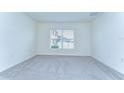 Bright bedroom with neutral carpet, natural lighting from the window, and clean, white walls at 38255 Sonnet Landing Ave, Zephyrhills, FL 33540