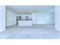 Open concept living space with kitchen island and stainless steel appliances at 38255 Sonnet Landing Ave, Zephyrhills, FL 33540