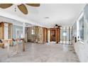 Spacious living room undergoing renovation with open layout, ceiling fans, and potential for customization at 411 Virginia Ave, Madeira Beach, FL 33708