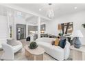 Open-concept living room and kitchen featuring modern decor and plenty of natural light at 4156 Gauge Line Loop, Tampa, FL 33624