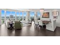A stylish living room with elegant furnishings, dark floors, and stunning water views at 450 Knights Run Ave # 1704, Tampa, FL 33602