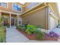 Beautiful townhome exterior with meticulously maintained landscaping, a paved walkway, and a warm, inviting entrance at 4739 Silverking Way, Palm Harbor, FL 34684