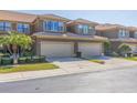 Inviting townhouse with a two-car garage, mature landscaping, and a well-maintained lawn in a desirable neighborhood at 4739 Silverking Way, Palm Harbor, FL 34684