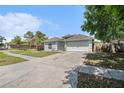 Beautiful home with a well-manicured lawn and spacious driveway leading to a two-car garage at 8941 Southbay Dr, Tampa, FL 33615