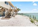 Quaint beach house with stairs to deck, palm trees, and amazing water views at 9696 Little Gasparilla Isand, Placida, FL 33946