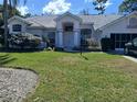 Charming single-story home with a well-manicured front yard and a beautiful tile roof at 14472 Linden Dr, Spring Hill, FL 34609