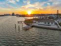 Sunset view of waterfront home with private dock and pool, offering serene living at 11005 5Th E St, Treasure Island, FL 33706
