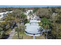 Unique home architecture featuring a flat roof, complemented by lush, mature landscaping and surrounding neighborhood at 1111 Dr M L King Jr N St, Safety Harbor, FL 34695