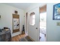 Bright entryway featuring a white front door with decorative glass and wood-look flooring at 12111 Scott Dr, Dade City, FL 33525