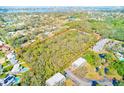 Beautiful aerial view of the expansive property and surrounding landscape with mature trees at 13450 Wilcox Rd, Largo, FL 33774