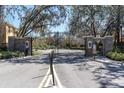 Community entrance gate flanked by stone walls and manicured landscaping at 13946 Snapper Fin Ln, Tampa, FL 33637