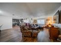 Open concept living room with wood floors, a comfortable leather couch, and a modern kitchen at 2223 Ivan Ct # 59, Sun City Center, FL 33573