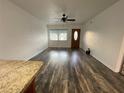 Bright living room featuring modern flooring, a ceiling fan, and a sunny window at 250 Rosery Nw Rd # 220, Largo, FL 33770