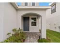 Inviting front entrance with an arched doorway and well-manicured garden at 33901 Floating Heart Ct, Wesley Chapel, FL 33545