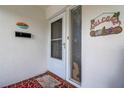 Close-up of front door entrance with welcome decor, and clean, freshly painted walls at 3550 100Th N Pl, Pinellas Park, FL 33782