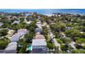 Aerial view of a neighborhood with mature trees and waterways in the distance at 4816 W San Jose St, Tampa, FL 33629