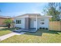 Inviting home exterior showcasing a fresh paint job, new landscaping, and a clean, modern aesthetic at 5050 Emerson S Ave, St Petersburg, FL 33707