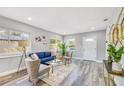 Bright living room with stylish furniture, modern decor, and ample natural light from large windows at 5050 Emerson S Ave, St Petersburg, FL 33707