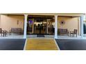 Building entrance featuring automatic doors, pillars, benches, and decorative accents at 5108 Brittany S Dr # 903, St Petersburg, FL 33715