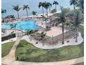 Scenic pool area overlooking the ocean surrounded by palm trees and white gravel at 5108 Brittany S Dr # 903, St Petersburg, FL 33715