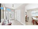 Welcoming foyer with decorative glass front door leading to dining area at 8436 White Poplar Dr, Riverview, FL 33578