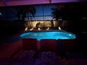 Inviting screened pool area with lounge chairs and tropical landscaping, perfect for relaxation at 8436 White Poplar Dr, Riverview, FL 33578