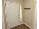 Clean entryway featuring a white front door with a window to the right and a welcome sign at 8642 Mallard Reserve Dr # 203, Tampa, FL 33614