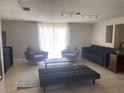 Bright living room featuring neutral tones, plush seating, and a tiled floor, creating a cozy and inviting atmosphere at 907 Fruitland Ave, Bradenton, FL 34207
