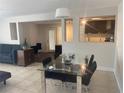 Modern living space with tile floors, an open layout to the kitchen, and ample natural light, perfect for relaxing or entertaining at 907 Fruitland Ave, Bradenton, FL 34207