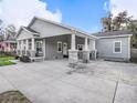 Side view of home featuring a covered carport with stone column base and lush landscaping at 1003 W Reynolds St, Plant City, FL 33563