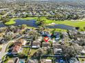 An aerial view pinpoints a beautiful single-Gathering home within a neighborhood near a golf course and pond at 11218 Longbrooke Dr, Riverview, FL 33579
