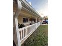 Cozy front porch with hanging swing, perfect for enjoying the outdoors at 1149 6Th Ne Ave, Largo, FL 33770
