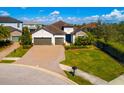 Aerial shot of a charming home featuring a two-car garage, brick driveway, manicured landscaping and stone detailing at 12031 Medley Ter, Lakewood Ranch, FL 34211