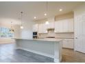 Bright kitchen features white cabinetry, granite countertops, stainless steel appliances, and a center island at 12031 Medley Ter, Lakewood Ranch, FL 34211