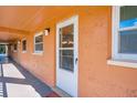 Exterior view featuring a white door, windows, and stucco walls, showcasing the side of the building at 12760 Indian Rocks Rd # 532, Largo, FL 33774
