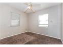 Cozy bedroom featuring neutral walls, carpet flooring, and natural light from the window at 1322 E Ohio St, Plant City, FL 33563