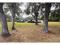 Charming single-story home with a well-manicured lawn and mature trees with Spanish moss at 1700 S Miller Rd, Valrico, FL 33594