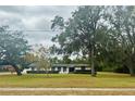 Charming single-story home with a well-manicured lawn and mature trees with Spanish moss at 1700 S Miller Rd, Valrico, FL 33594