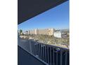 Balcony view showcasing parking, nearby building, and waterfront in the distance on a bright sunny day at 1868 Shore S Dr # 608, South Pasadena, FL 33707