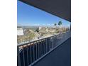 Balcony view showcasing parking, nearby building, and waterfront in the distance on a bright sunny day at 1868 Shore S Dr # 608, South Pasadena, FL 33707