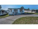 Inviting single-story home with covered parking and a convenient ramp for accessibility at 196 Philadelphia Blvd # 10, Palm Harbor, FL 34684