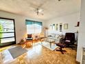 Cozy living room with lots of natural light, comfortable seating, and parquet flooring at 2476 Enterprise Rd # 6, Clearwater, FL 33763