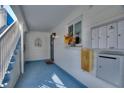 A cozy condo entrance with a blue painted floor and stairs, mailboxes, and door decor at 4400 37Th S St # 2, St Petersburg, FL 33711