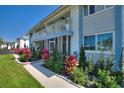 Beautifully landscaped condo exterior featuring colorful plants and a well-kept walkway at 4400 37Th S St # 2, St Petersburg, FL 33711