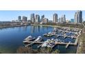 Aerial daytime view of marina with yachts docked and city skyline in the background at 555 5Th Ne Ave # 711, St Petersburg, FL 33701